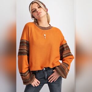 Vibrant Orange Knit Sweater with Patterned Sleeves